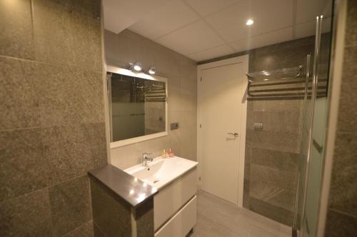 La salle de bains est pourvue d'un lavabo et d'une douche. dans l'établissement Apartamento Victoria, à Cadix