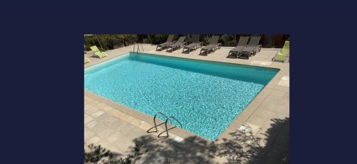 an overhead view of a swimming pool with lounge chairs at Maison haut de gamme dans le golf de pont royal in Mallemort