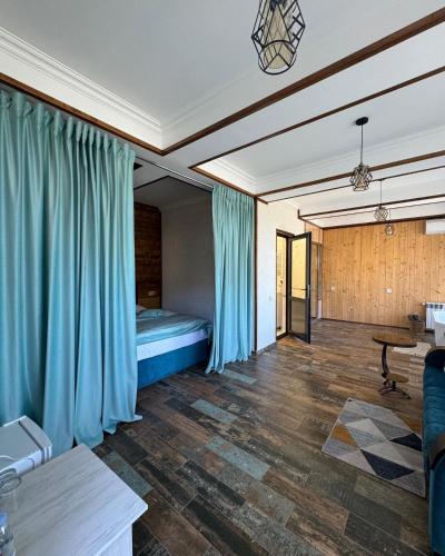 a bedroom with a bed with blue curtains in it at Harsnadzor Eco Resort in Halidzor