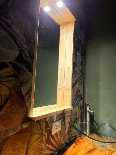 a bathroom with a glass sink and a mirror at Chalet Luna y Miel in Dulce Nombre