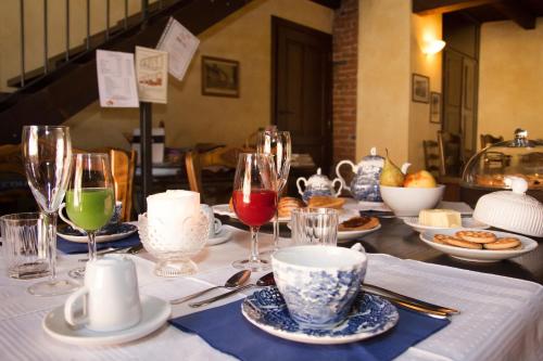 a table with wine glasses and plates of food at Casa Del Grande Vecchio in Airasca