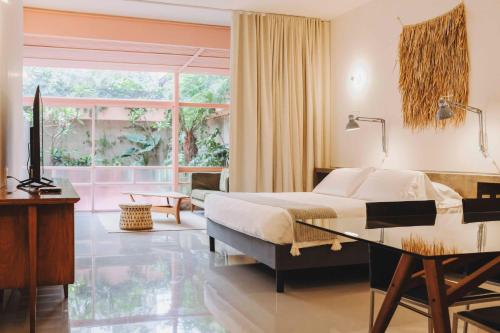 a bedroom with a bed and a desk and a window at Xolo stays in Mexico City