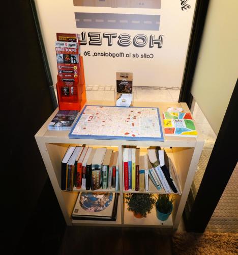 a small refrigerator filled with books and textbooks at Madrid Downtown Hostel in Madrid