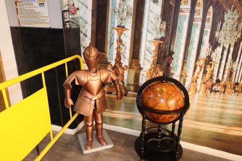 a statue of a man standing next to a ball at Madrid Downtown Hostel in Madrid