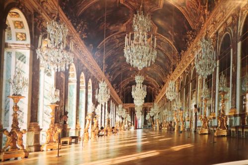 a large room with chandeliers in a palace at Madrid Downtown Hostel in Madrid