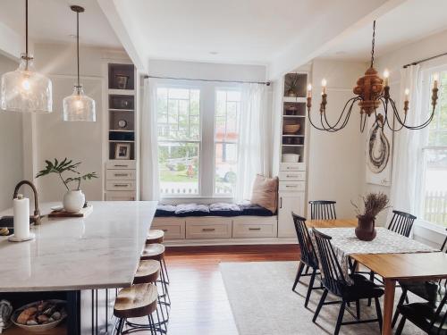 a kitchen and dining room with a table and chairs at Guesthouse on Girod in Mandeville