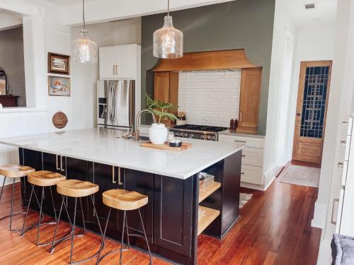a kitchen with a large island with wooden stools at Guesthouse on Girod in Mandeville