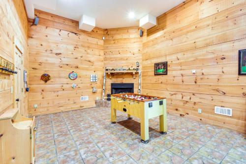 a game room with wooden walls and a ping pong table at Expansive Sky Valley Lodge with Mountain Views! in Sky Valley