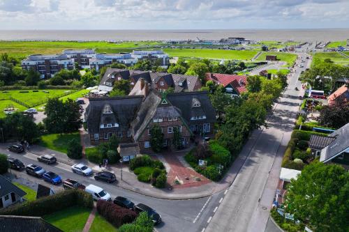 an aerial view of a town with houses and the ocean at Ferienhaus "Moby Dick" Mellumplate 44 in Dorum Neufeld