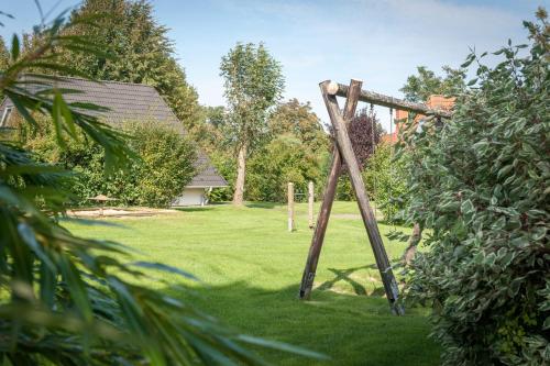 a wooden frame in the grass in a yard at Cuxlandhotel Doppelzimmer 118 in Dorum Neufeld