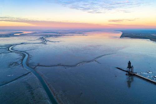 an aerial view of a lighthouse in the water at Cuxlandhotel Doppelzimmer 115 in Dorum Neufeld