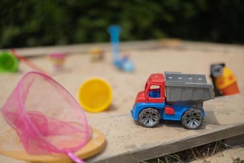 a toy truck sitting on a table near a toy park at Cuxlandhotel Doppelzimmer 119 in Dorum Neufeld