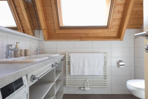 a bathroom with two sinks and a white towel at Ferienhaus Mellumplate 50 in Dorum Neufeld
