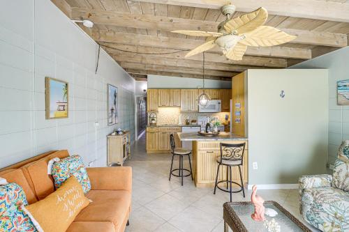 a living room with a couch and a kitchen at Waterfront Key Colony Beach Home with Golf Cart! in Key Colony Beach