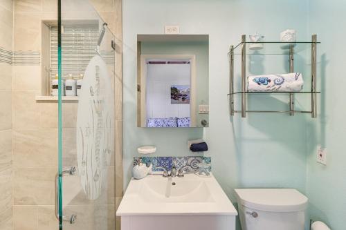 a bathroom with a toilet and a sink and a shower at Waterfront Key Colony Beach Home with Golf Cart! in Key Colony Beach