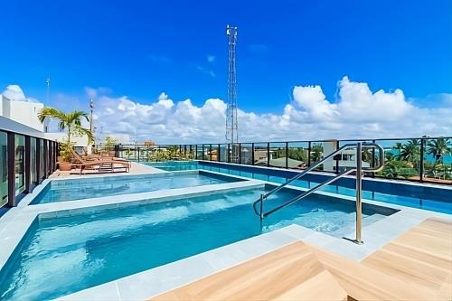 a swimming pool on the roof of a building at Flat Porto Blue 104 - Centro Porto de Galinhas in Porto De Galinhas