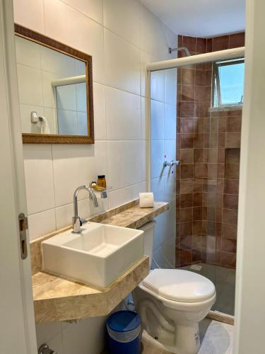 a bathroom with a sink and a toilet at Pousada do Lago in Guaramiranga