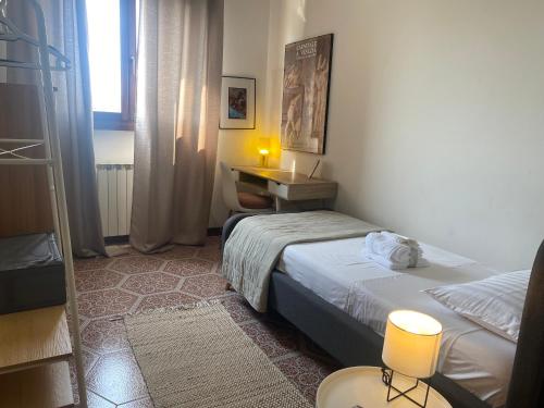 a bedroom with two beds and a desk and a window at Al B6 CLOSE TO VENICE in Mogliano Veneto