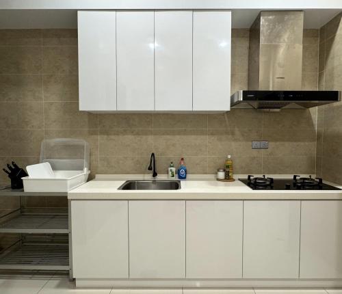a kitchen with white cabinets and a sink at Hillside House, Ipoh Garden, Max 9 pax, Hillview, No parties & events, No pets in Ipoh