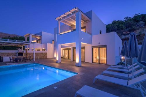 a house with a swimming pool in front of it at Villa Krini Delight in vlicha