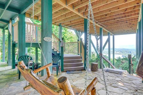 a porch of a house with a porch swing at Hiawassee Home with Fire Pit and Furnished Deck! in Hiawassee