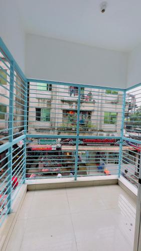 a view of a building with blue metal cages at Mohammadia Restaurant & Guest House in Dhaka