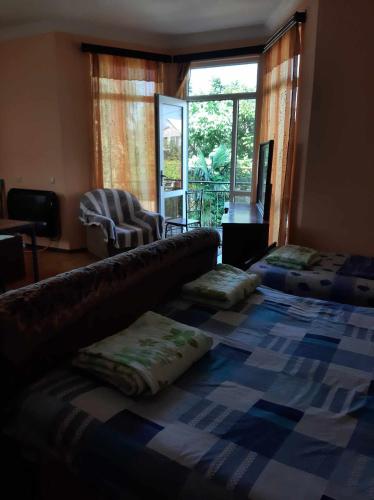 a bedroom with a large bed with pillows on it at Hotel Resanda in Kobuleti