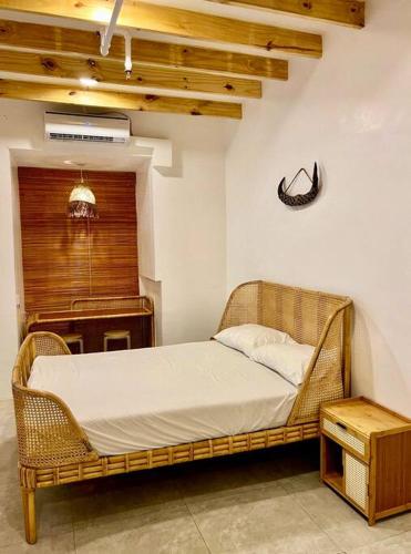 a wicker bed in a room with a piano at Bohemian Moderns Style Living- Free Pool- Pet Friendly in Manila