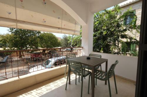 a table and chairs on a balcony with a view at Central Apartments in Kardamili