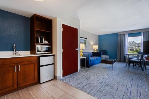 a room with a kitchen and a living room at Holiday Inn Express & Suites Cincinnati Riverfront by IHG in Covington