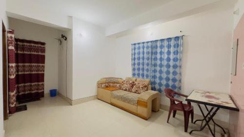 a living room with a couch and a table at Mohammadia Restaurant & Guest House in Dhaka