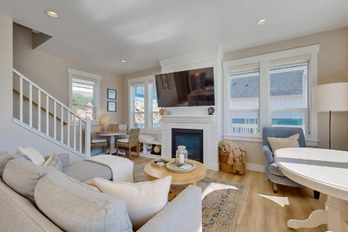 a living room with a couch and a fireplace at Pacific Breeze in Lincoln City