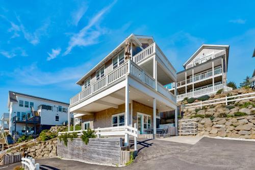 a house on the beach with a stone wall at Pacific Breeze in Lincoln City