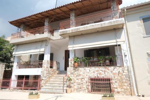 a house with stairs and a balcony at Central Apartments in Kardamili