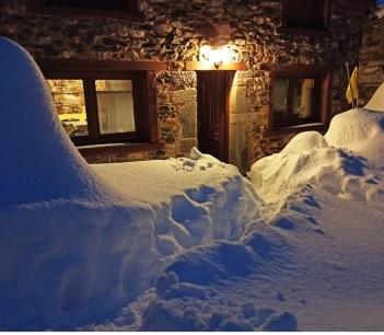a pile of snow in front of a house at Casa Aires de Pajares in Camplongo
