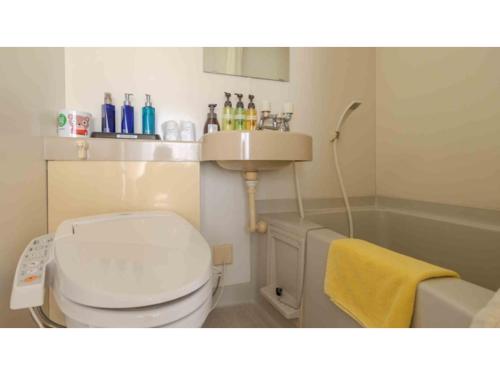 a bathroom with a white toilet and a sink at COCOLAND - Vacation STAY 73928v in Ube