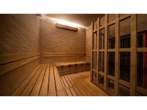 an empty sauna with wooden floors and wooden doors at COCOLAND - Vacation STAY 73987v in Ube