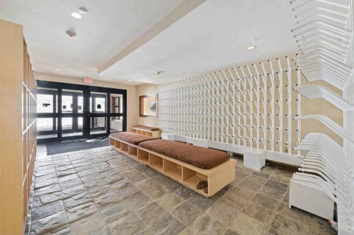 a room with a bench in the middle of a room at Highlands Westview 105 by East West Hospitality in Beaver Creek