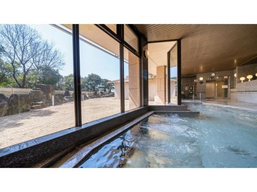 a large swimming pool in a house with windows at COCOLAND - Vacation STAY 73959v in Ube