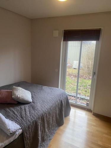 a bedroom with a bed and a large window at Villa Valencia Falkenberg in Falkenberg