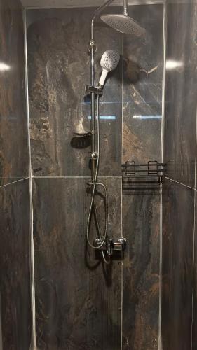 a shower with a shower head in a bathroom at Villa Burçin Apart in Dalyan