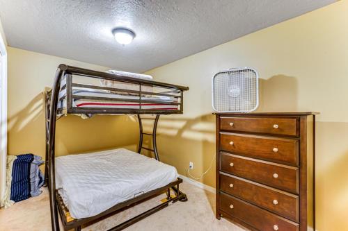 a bedroom with a bunk bed and a dresser at Sprawling Utah Mansion with Private Hot Tub and Sauna in Draper