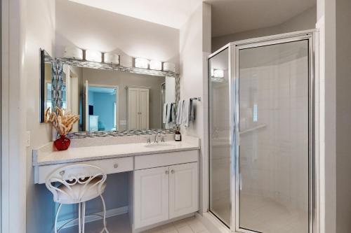 a bathroom with a shower and a sink and a mirror at Spring Lake --- 38167 West Dr. #716 in Rehoboth Beach
