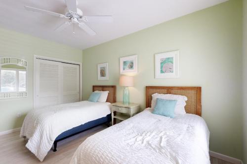 a bedroom with two beds and a ceiling fan at Spring Lake --- 38167 West Dr. #716 in Rehoboth Beach