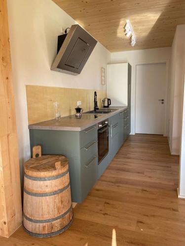 a kitchen with a counter and a wooden floor at Haus 7&50 in Bolsterlang