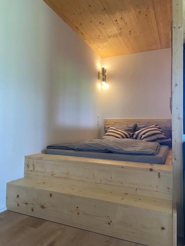 a bed with a wooden frame in a room at Haus 7&50 in Bolsterlang