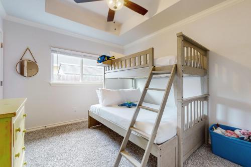 a childs bedroom with bunk beds and a ceiling fan at Gulf Coast Haven in Aransas Pass