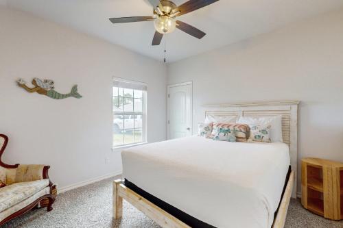 a bedroom with a bed and a ceiling fan at Gulf Coast Haven in Aransas Pass