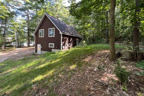 a small house on a hill in the woods at Moose & Red Fox Retreat in Denmark