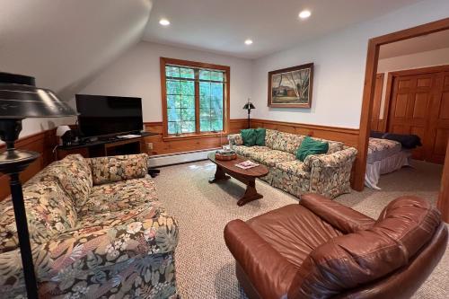 a living room with two couches and a television at Moose & Red Fox Retreat in Denmark